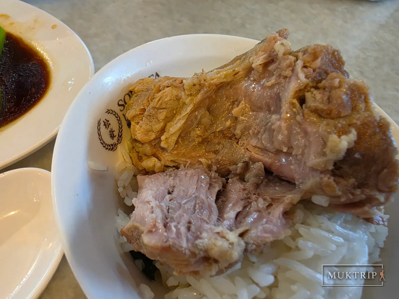 Large pieces of pork rib meat served over white rice