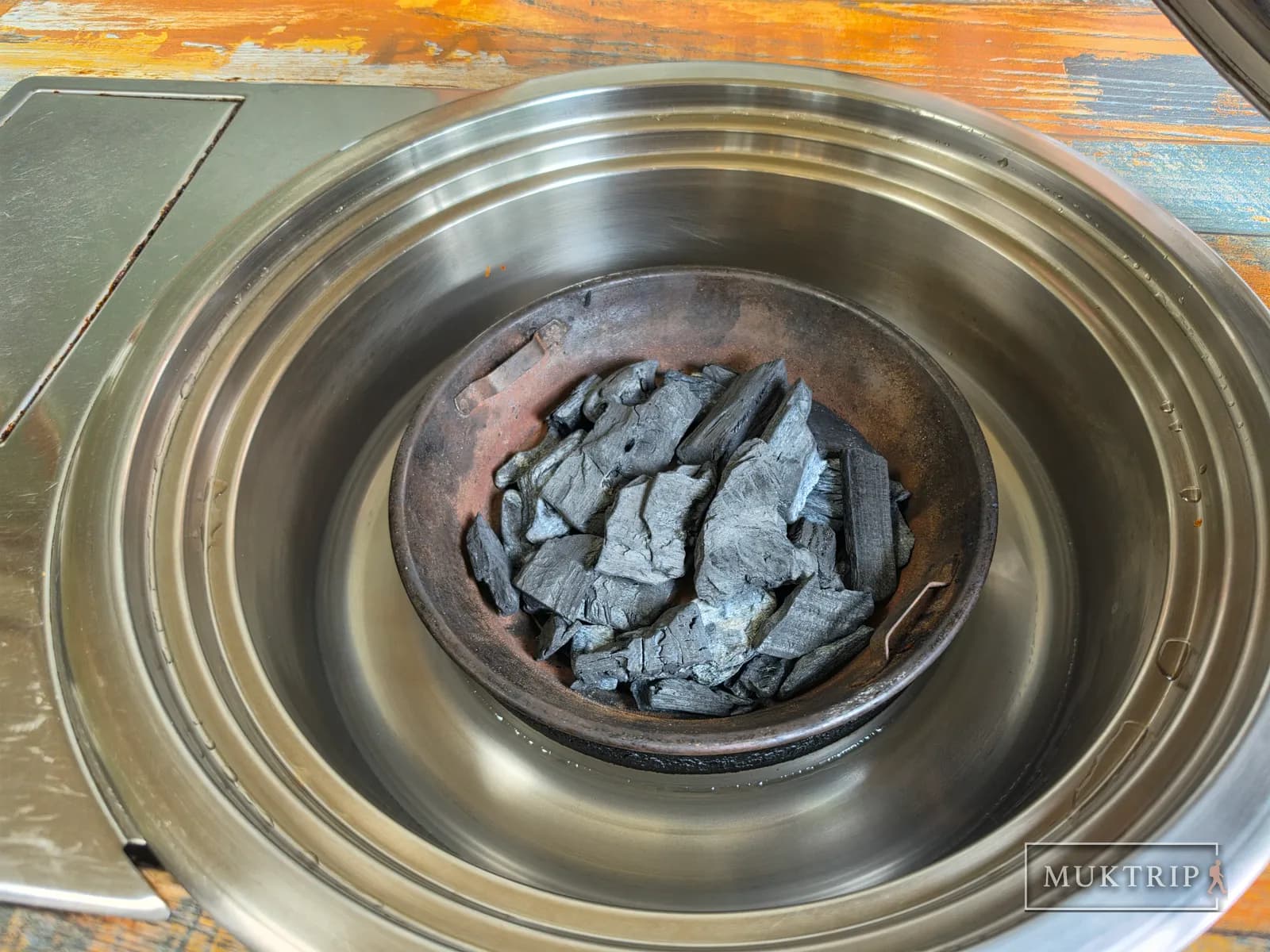 Charcoal piled inside a brazier set on the table