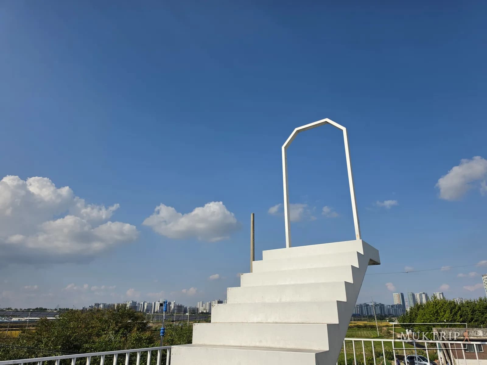 A Stairway to Heaven photo zone climbing toward the blue sky