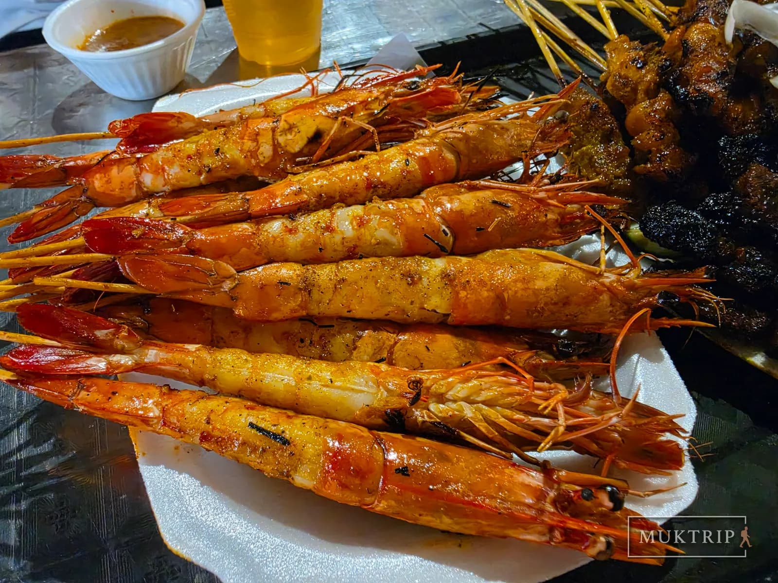 Grilled prawn skewers with the shell removed from the body