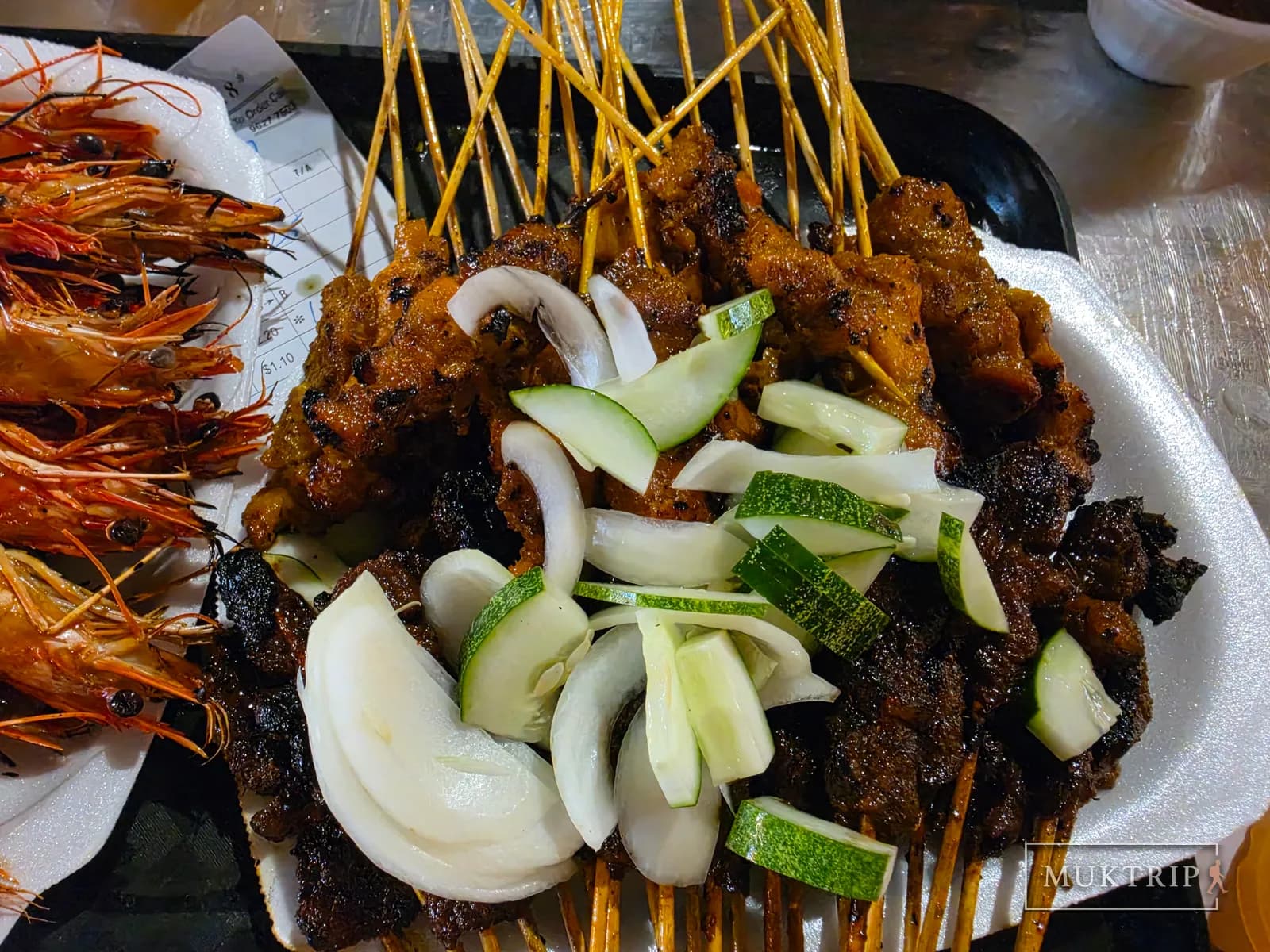 Onion and zucchini piled generously on top of satay skewers