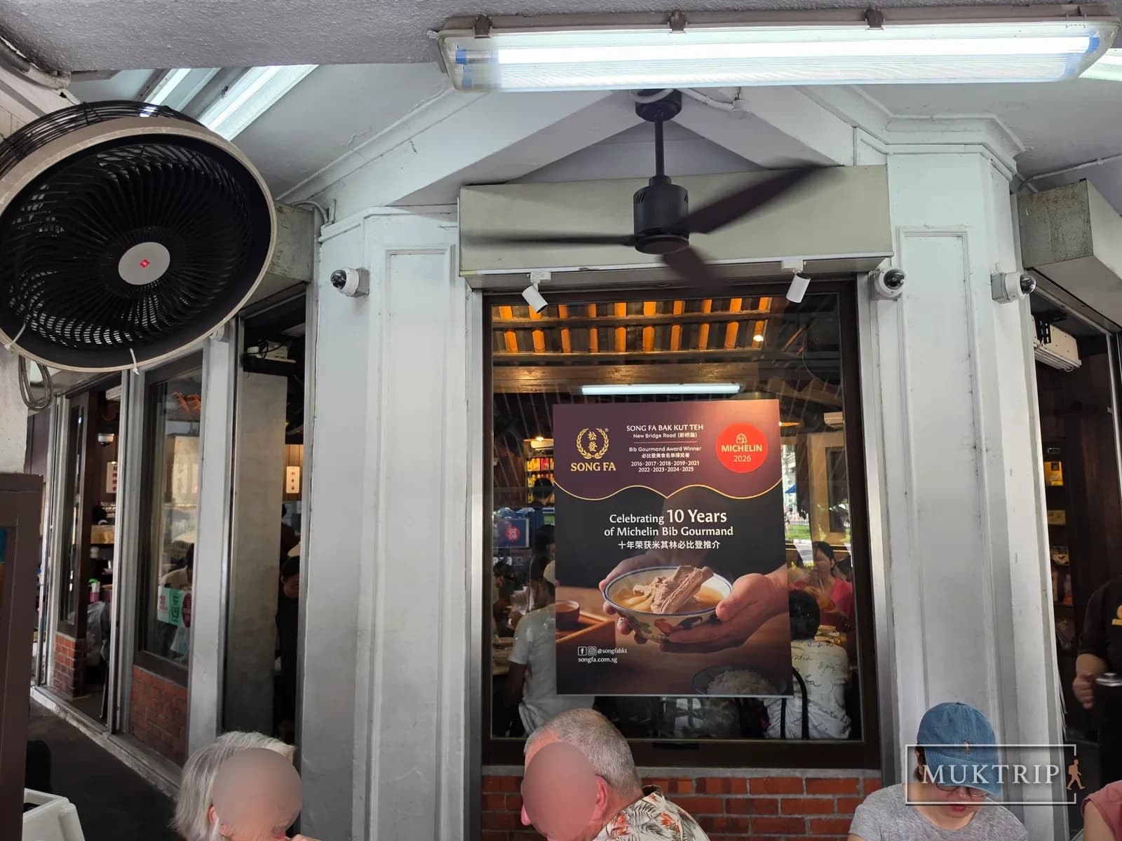 Entrance with a poster celebrating the 10th anniversary of the Michelin Bib Gourmand
