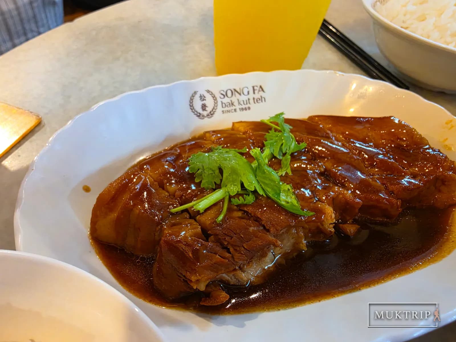 Song Fa Bak Kut Teh braised pork belly plate topped with cilantro