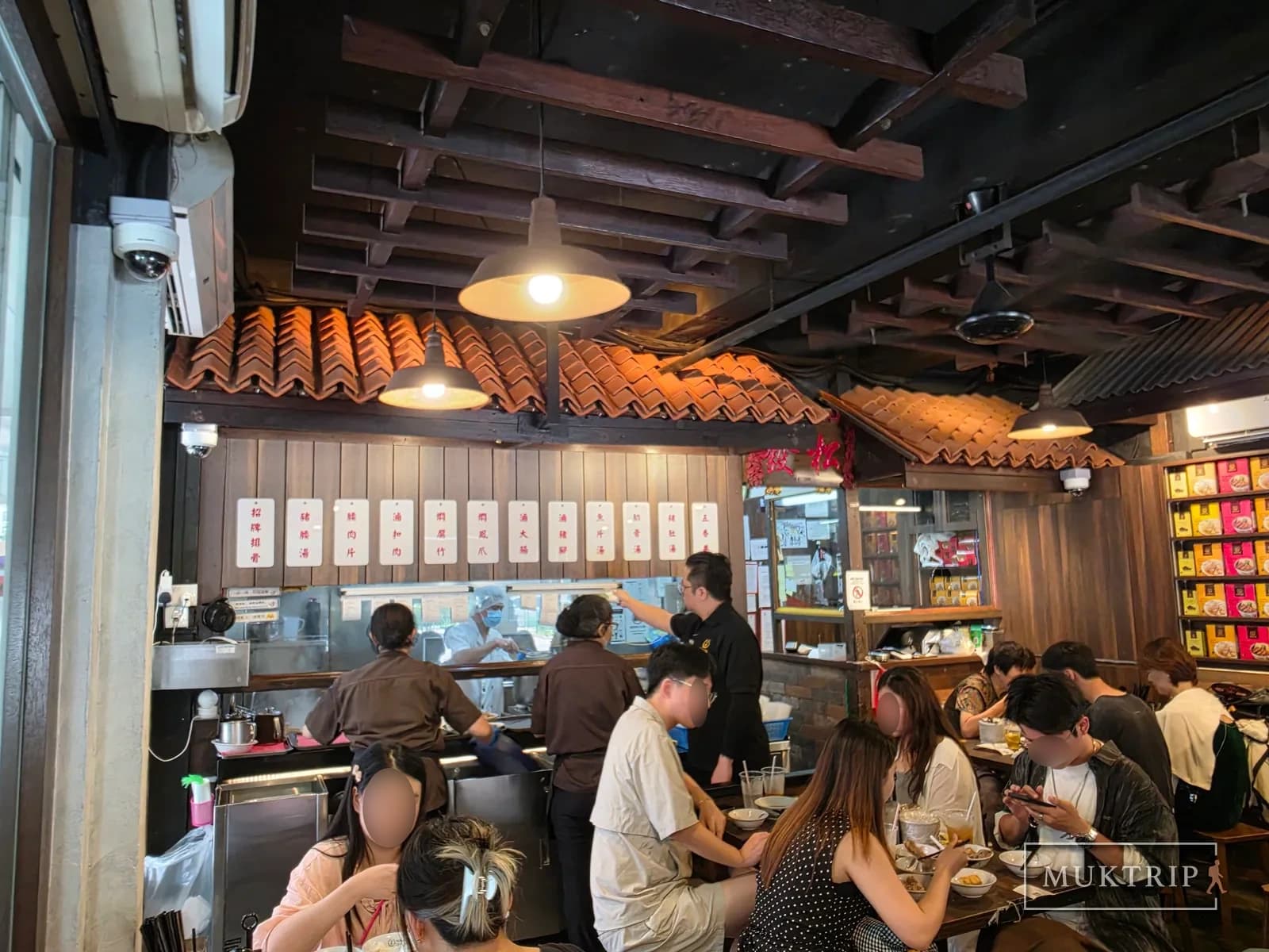 The bustling interior and kitchen of Song Fa Bak Kut Teh (11 New Bridge Road), crowded with customers