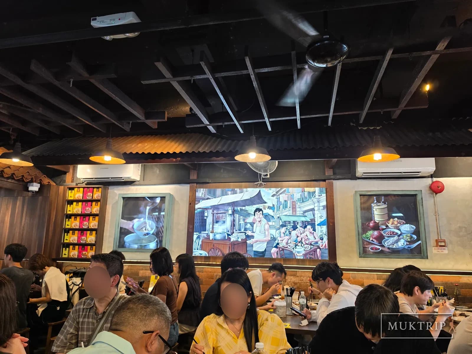 Framed paintings on the wall at Song Fa Bak Kut Teh (11 New Bridge Road) and customers dining