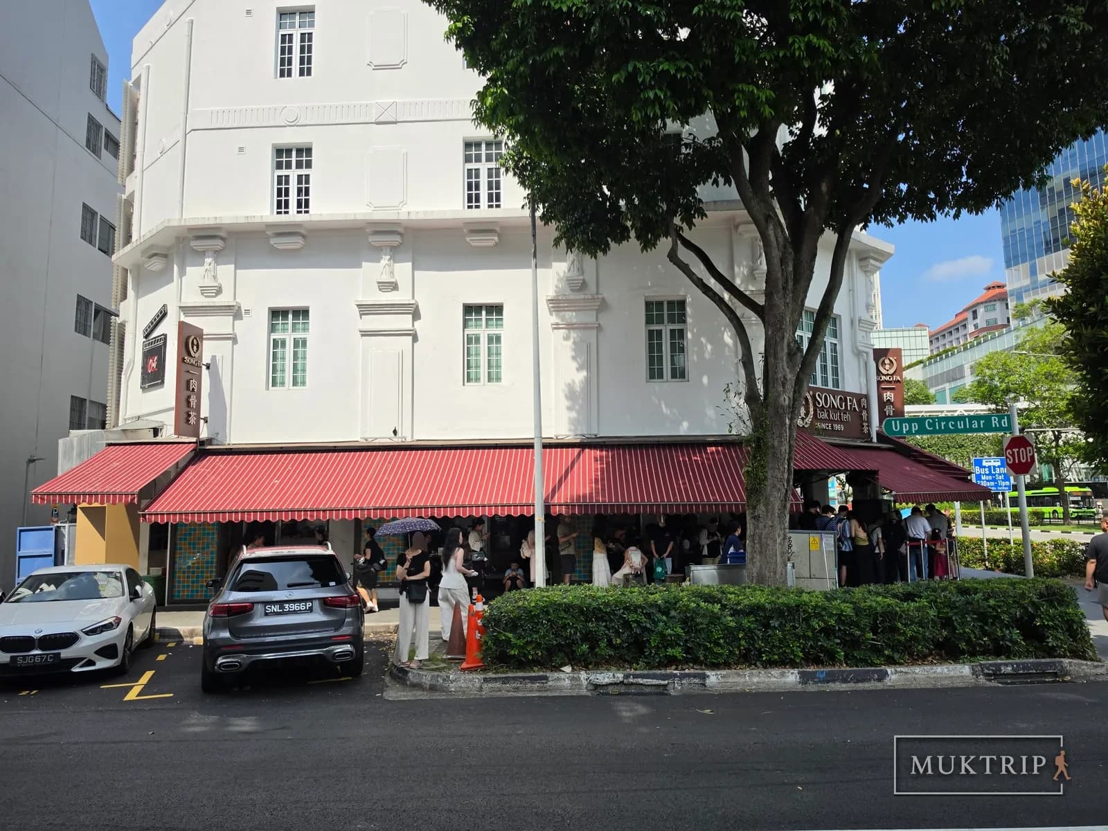 The white corner building housing Song Fa Bak Kut Teh (11 New Bridge Road) with its red awning