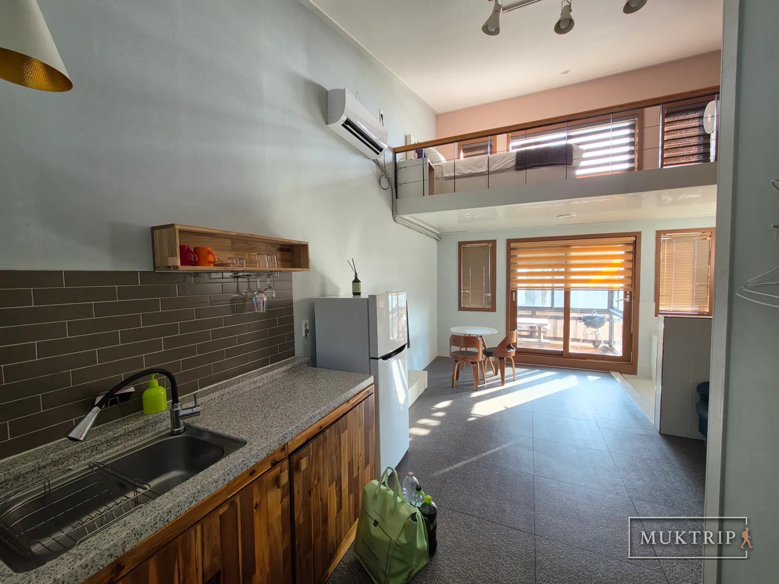 The kitchen and living room space of a loft-structured pension room