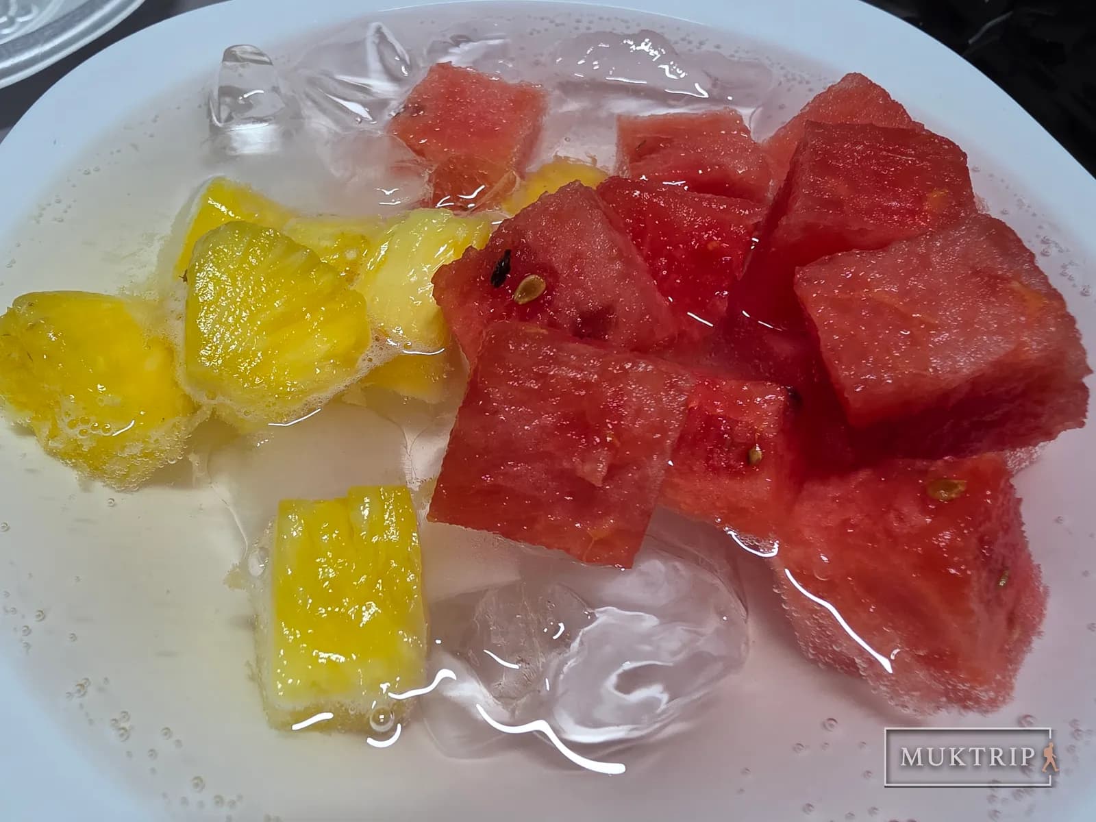 Pieces of watermelon and pineapple in sprite